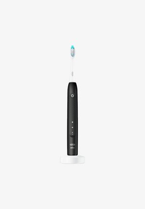 Black electric toothbrush with white brush head, textured grip, power button, and charging base on a white background.