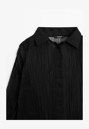 Zwarte, gekreukelde overhemd met puntige kraag, voorzien van zwarte knopen en een gestructureerd, lichtgewicht stoffen ontwerp.