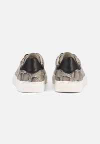Sneakers with a textured snake print upper in gray and beige, featuring a black leather heel cap and white rubber sole.