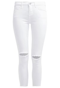 Vita smala jeans med medelhög midja, med två knärevor med fransar, tillverkade av stretchigt denim för en åtsittande silhuett.