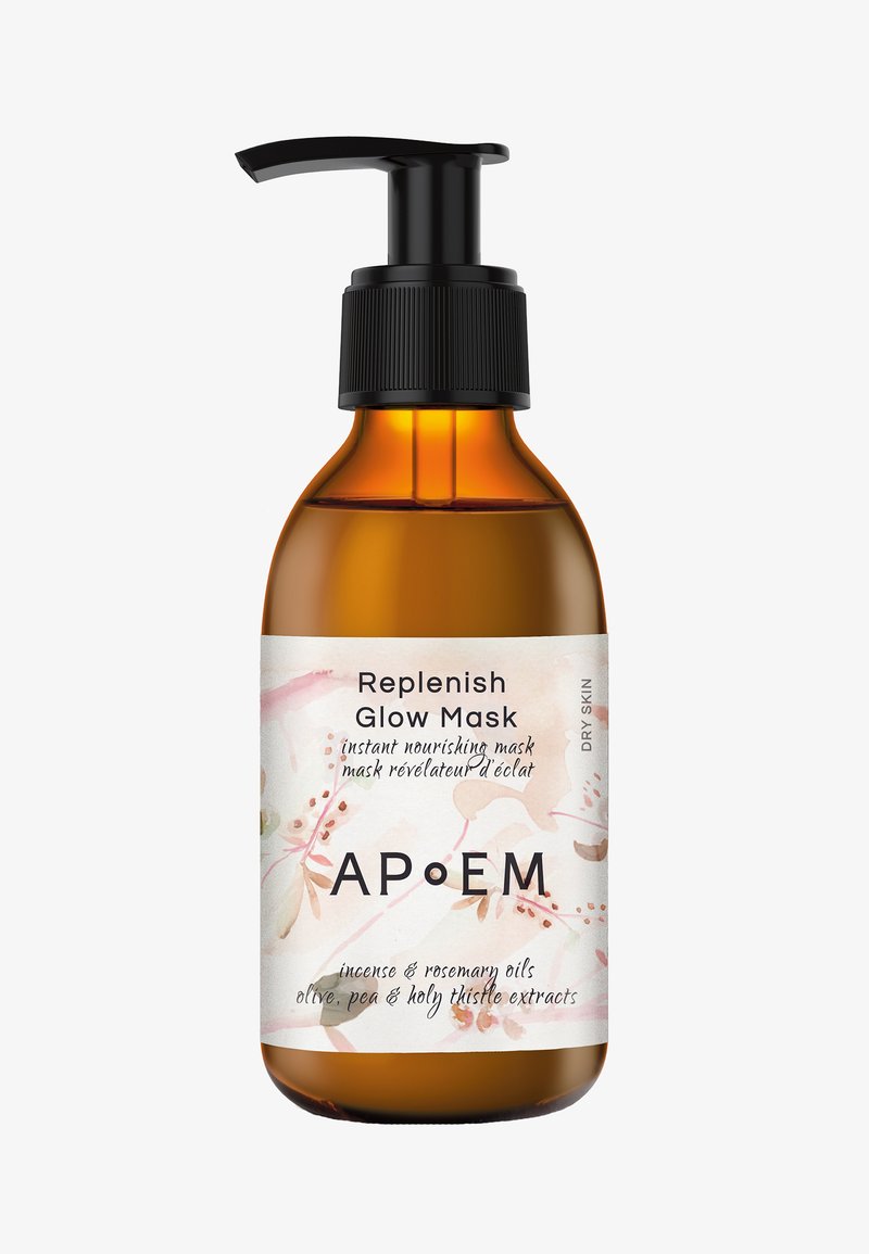 Amber glass bottle with a black pump and label featuring floral design. Text includes "Replenish Glow Mask" and ingredients like olive and rosemary oils.
