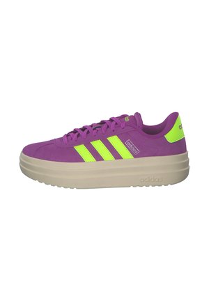 Purple suede sneaker with bright green stripes, round toe, and thick beige sole. Features flat laces and branding on the side.