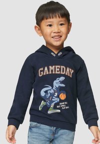 Navyblauwe hoodie met een dinosaurustekening, de tekst "GAMEDAY" en een basketbalmotief. Gemaakt van katoen met ribbels aan de mouwen en onderkant. Casual ontwerp.