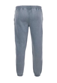 Grå joggebukser med elastisk talje, elastiske bundender og sidelommer. Fremstillet af blødt stof med en glat tekstur.