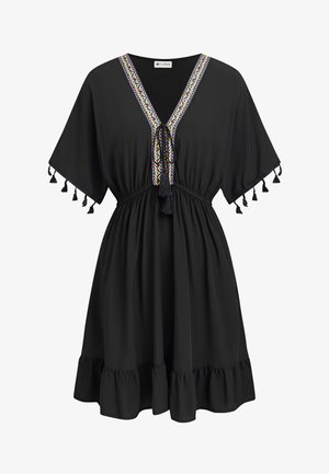 Robe noire longueur genou avec décolleté en V brodé, liens à pompons, manches larges avec pompons, taille cintrée et ourlet à volants.