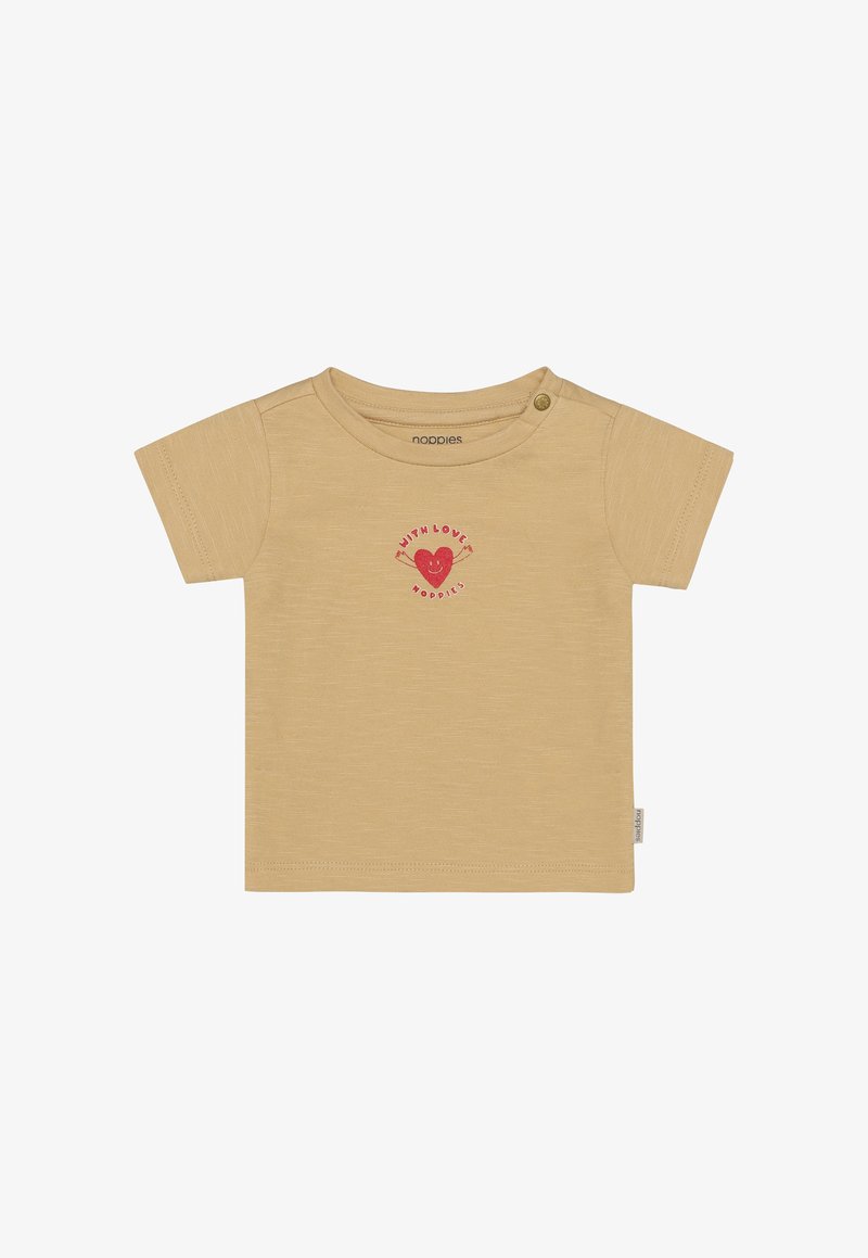 T-shirt beige clair à manches courtes en tissu doux, avec un graphique de cœur rouge accompagné du texte "avec amour" et une fermeture à boutons-pression sur le côté pour un habillage facile.