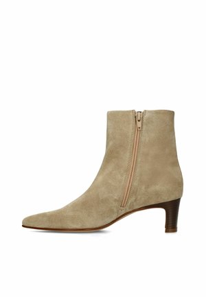 Light brown suede ankle boot with a side zipper and low stacked heel, shown in a right-side profile view.