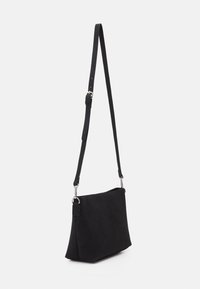 Bolso cruzado de ante negro con forma rectangular plana, correa ajustable y acentos de hardware plateado. Textura suave y sin patrones visibles.