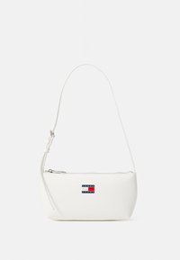 White leather shoulder bag with a curved shape, zip closure, and a small logo patch in blue, red, and white on the front.