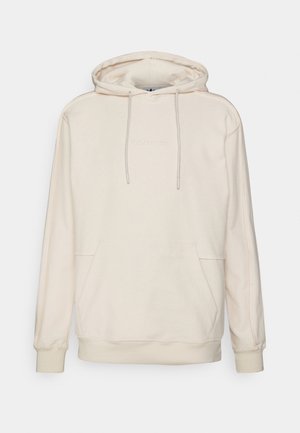 Sudadera crema con capucha ajustable y bolsillo tipo canguro en la parte frontal. Fabricada en material suave con puños y dobladillo acanalados. Logo de Adidas bordado en blanco.