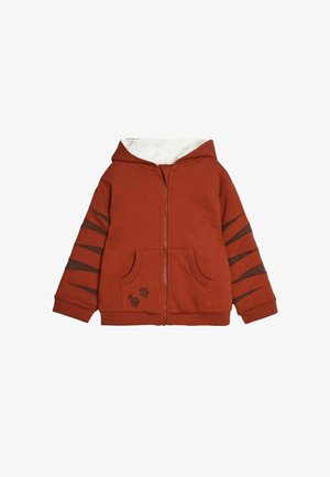 Hanorac cu fermoar în față, de culoare ruginie, dintr-un material texturat, cu două buzunare laterale și urme de gheare pe mâneci. Interior moale, căptușit.