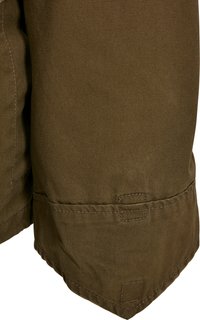 Brown cotton fabric with a textured finish, featuring stitched hems and square accents. Focus on the lower section and edge details.