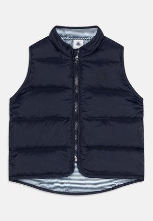 Granatowa pikowana kamizelka bez rękawów z zamkiem błyskawicznym z przodu i paskowanym wewnętrznym podszyciem, z małym wytłoczonym logo na piersi.