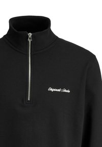 Black zip-up sweatshirt with a high collar, featuring a silver zipper and white embroidered text that reads "Originals Studio." Soft texture.