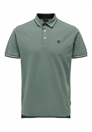 Polo verde realizzato in cotone, con colletto classico, patta con tre bottoni, polsini a righe a contrasto e logo ricamato.