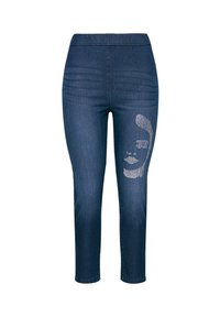 Džínové kalhoty v tmavě modrém odstínu, s elastickým pasem a stříbrnou grafikou obličeje na levé nohavici. Slim fit s hladkou texturou.