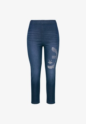 Jeans aus Denim in einem dunkelblauen Farbton, mit elastischem Bund und einem silbernen Gesichtsgrafik auf dem linken Bein. Slim-Fit mit glatter Textur.