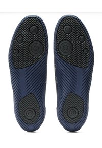Dark blue shoe soles with a textured black rubber grip. Features circular and oval traction patterns and diagonal ribbed detailing.