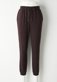 Bordeauxfarbene Jogginghosen aus weichem Material, mit elastischem Bund und Kordelzug, schlanker Schnitt und tapered Knöchel mit elastischen Bündchen.
