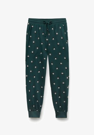 Un pantalon de survêtement vert avec une taille élastique et un cordon de serrage, présentant un motif répété de designs circulaires en noir, blanc et gris.
