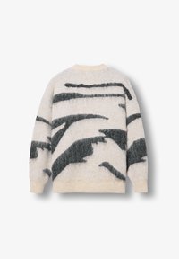 Kellemes, krémszínű pulóver bolyhos textúrával; merész fekete absztrakt csíkokkal díszítve. A bordás mandzsetták és az alsó szegély teszik teljessé a megjelenést.