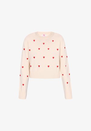Beżowy krótki sweter z długimi rękawami, z czerwonymi wzorami serc w całej powierzchni. Wykonany z miękkiego, dzianinowego materiału z prążkowanym wykończeniem.