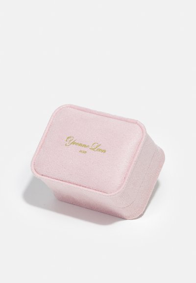 Pink velvet jewelry box with rounded edges, featuring gold text "Yvonne Leon Paris" on the lid, provides a soft textured appearance.