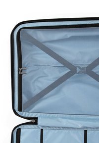 Light blue suitcase interior with mesh zippered compartments, black accents, and crisscross straps for organization. Smooth fabric texture.