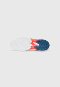 Shoe sole featuring a white textured pattern, vibrant orange midsole, and a blue heel section with pronounced treads for grip.