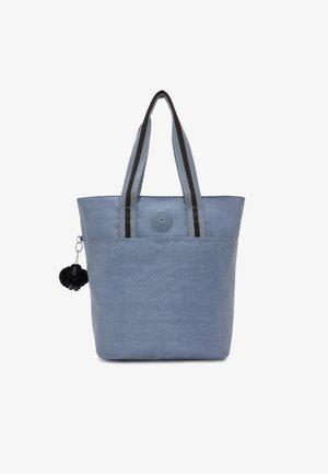 Light blue tote bag with a textured finish, featuring black and grey striped handles, a round logo button, and a black pom-pom accessory.