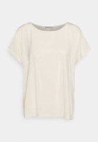 Top corto color crema con maniche a giro, realizzato in tessuto morbido, caratterizzato da una vestibilità ampia e fessure laterali all'orlo.