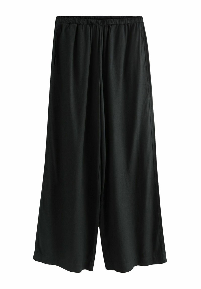 Schwarze weite Stoffhosen aus weichem Material, mit elastischem Bund und seitlichen Taschen, einem glatten Gefühl und fließendem Schnitt.