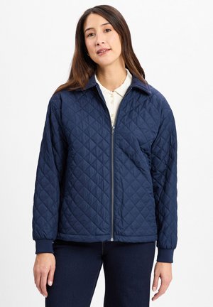 Marineblau gesteppte Jacke mit Reißverschluss, Stehkragen und gerippten Bündchen. Verfügt über ein Rautenmuster auf dem Stoff und hat eine lockere Passform.