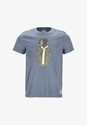 T-shirt en coton bleu avec un dessin animé de Rottweiler portant des lunettes de soleil et une veste verte sur un hoodie blanc, imprimé sur le devant.
