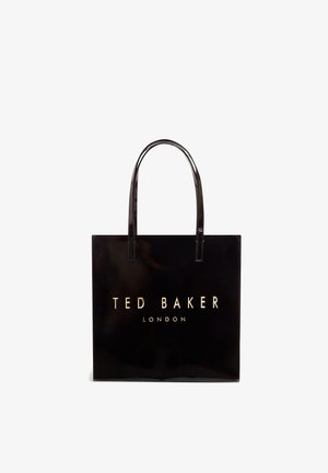 Μαύρη γυαλιστερή τσάντα ώμου με δύο μακριές λαβές, με χρυσά γράμματα «TED BAKER LONDON» στο μπροστινό μέρος. Ορθογώνιο σχήμα, λεία υφή.