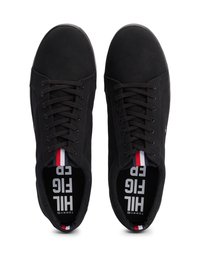 Black canvas low-top sneakers with tonal laces, rubber sole, and striped accents in red, white, and blue. Logo visible on insoles.