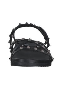 Black sandals with multiple straps featuring metallic pyramid studs. The sole is flat and textured, providing a secure fit.