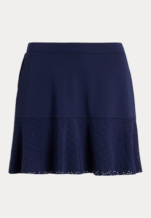 Marineblå skjørt laget av teksturert stoff, med en utsvingt design, perforerte detaljer langs kanten og en elastisk midje.