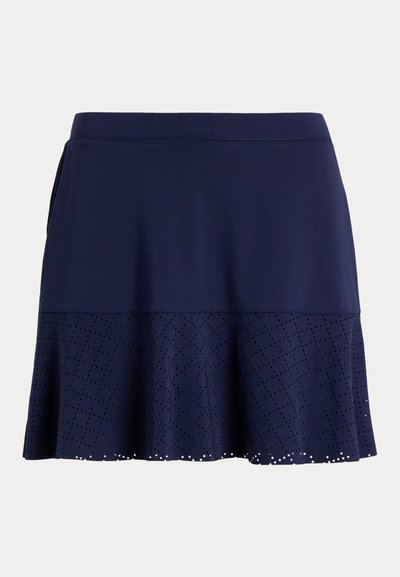 Marineblå skjørt laget av teksturert stoff, med en utsvingt design, perforerte detaljer langs kanten og en elastisk midje.