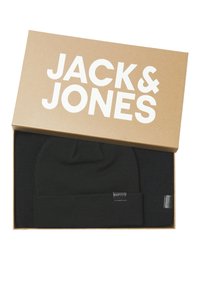 Black knit beanie and scarf set in a brown box featuring white "JACK & JONES" logo. Items have textured fabric and brand labels.