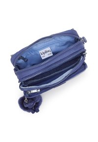 Purple Kipling wallet with multiple zippered compartments, smooth fabric, and a plush pom-pom keychain. Interior features a light blue lining.