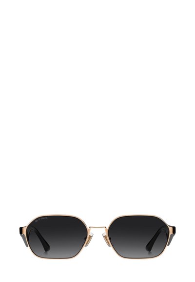 Lunettes de soleil en métal doré avec une forme octogonale, des accents noirs et des verres dégradés foncés. Caractérisées par un design minimaliste et des plaquettes de nez transparentes.