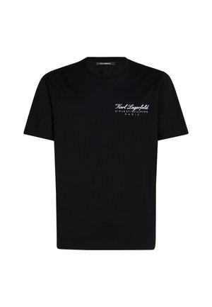 Musta puuvillapaita, jossa on pyöreä kaula-aukko, lyhyet hihat ja valkoinen painatettu logo, jossa lukee "Karl Lagerfeld" ja "21 RUE ST-GUILLAUME PARIS."