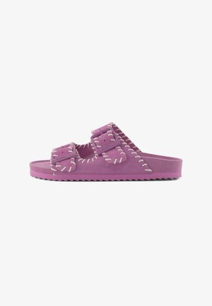 Purple suede slide sandal with two adjustable buckles and white decorative stitching along edges.
