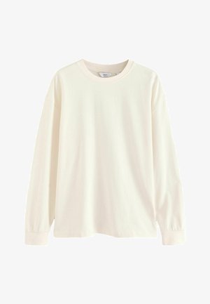 Langärmliges Creme-Cotton-T-Shirt mit Rundhalsausschnitt und lockerer Passform, ausgestattet mit überschnittenen Schultern und gerippten Bündchen für zusätzlichen Komfort.