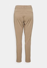 Pantaloni beige a vita slim, con cintura dotata di passanti per cintura, due tasche posteriori e una texture del tessuto liscia.
