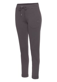 Graue Sweatpants aus weichem Material, mit einem Kordelzugbund, schmal zulaufenden Beinen und kleinem gesticktem Logo auf der Vorderseite.