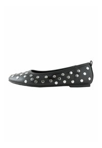 Black flat shoe made of synthetic material, featuring circular silver studs along the upper, with a rounded toe and minimal heel.