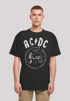 Black cotton t-shirt featuring a white graphic of a cannon, star accents, and the text "AC/DC FOR THOSE ABOUT TO ROCK 1981."