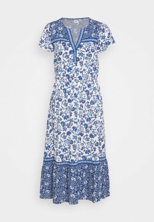 Valkoinen midi-mittainen mekko, jossa on lyhyet hihat, sininen kukkakuvio, V-aukko ja leveä tummansininen paisley-kuvioinen helma.